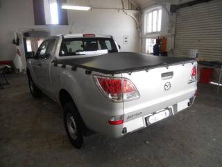 The standard Rope Tonneau Cover- fitted stainless steel rod- clips included